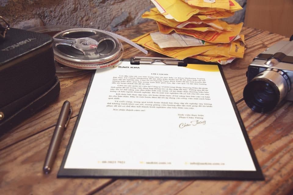 Signed document on a clipboard on a wooden desk