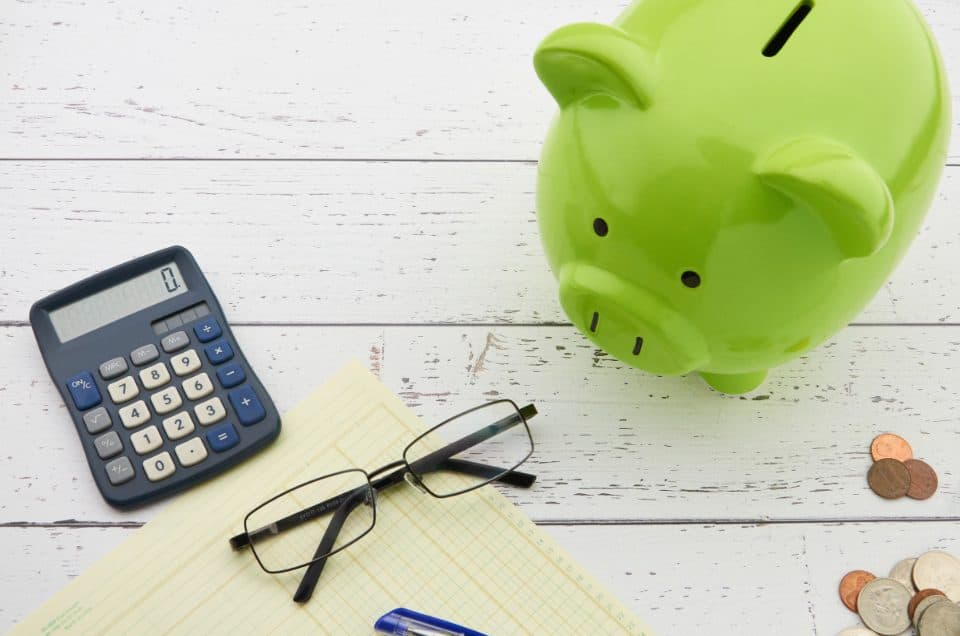 Piggy bank, calculator and coins for savings and SIP planning